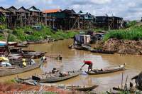 CAMBODIA, Siem Reap. Kompong Phluk village; houses on stilts due to seasonal flooding of Tonle Sap lake.