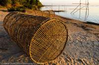 CAMBODIA, Stung Treng. Fish traps on beach beside Mekong River. Sunset.