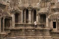 CAMBODIA, Siem Reap, Temples of Angkor.  Cleaner sweeps, and provides scale, within central towers of Angkor Wat temple complex, built in 12th century.