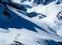 NEPAL, Dolpo. Porters traversing snow below Yala La pass (5300m).