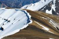NEPAL, Dolpo. Trekkers traversing high (5000m), bare ridge above Pho village and Tora Khola valley.