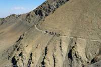 NEPAL, Dolpo. Trekkers on hill-side trail above Tartang Khola valley.