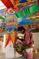 Skilled painters work on murals for new (under construction) Buddhist monastery.