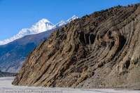 NEPAL. Dhaulagiri (8167m, 7th highest mountain on Earth) rises beyond braided river bed of Kali Gandaki River, dry season. Folded rocks are indicative of geological forces and massive uplift of Himalaya Range.