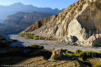 NEPAL. Harvested field and eroding cliffs, Kali Gandaki valley, Mustang.
