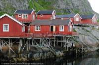 NORWAY, Nordland. Lofoten Islands, Moskenesoy. Harbour-side roburer (fishermen's shacks) in village of Å.