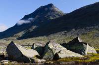 NORWAY, Oppland, Jotunheimen National Park. Glacial erratic boulders & lake, Mjolkedalen valley.