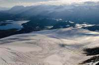 NORWAY, Oppland, Jotunheimen National Park. Ogives (seasonal layering) exposed in surface of Fannarakbreen glacier, Prestesteinsvatnet lake beyond, Smorstabreen glacier in distance.