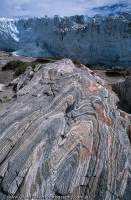 Banded gneiss rock and terminal face of Russell Glacier, one of countless small glaciers draining from the Greenland icecap, West Greenland (Kitaa)