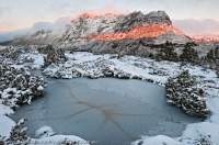 Dawn light on east face of Cradle Mountain, with autumn snow. Cradle Mountain - Lake St Clair National Park, Tasmanian Wilderness World Heritage Area.