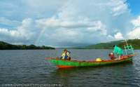 Fishing boat and rainbow on Koh Kok Pao (river), Koh Kong, Cambodia.