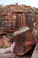 AUSTRALIA, Western Australia, West Kimberley. Sandstone boulder and cliff, lower Charnley River gorge