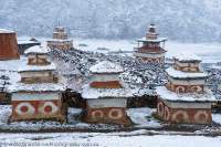 NEPAL, Dolpo. Chortens and mani stone field at Shey Gompa (Buddhist), in snow.
