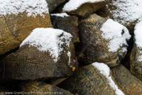 NEPAL, Dolpo. Mani stones at Shey Gompa, in snow.