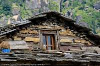 Window & roof detail of traditional-style house in village above Manali, Kulla Valley.