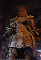 Wooden statue of Komoku-ten, the Guardian King of the South, holding a writing brush and scroll symbolizing the copying of sutras, in Daibutsu-den hall at Todai-ji temple, Nara-koen.