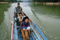 LAOS, Luang Prabang, Muang Ngoi Neua. Local women in longtail boat on Nam Ou river.