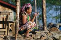 NEPAL. Women smoking oustide house, Arun valley,Makalu Base Camp Trek.