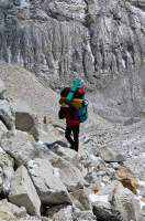 NEPAL. Sherpa porter ascending moraine, Makalu - Barun National Park.