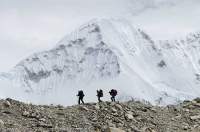 NEPAL. Trekkers descending moriane crest in upper Honku valley, Makalu - Barun National Park.