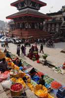 NEPAL, Kathmandu. Flower & vegetable sellers at base of Maju Deval Temple, Durbar Square.