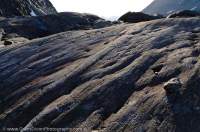 NORWAY, Troms, Lyngsalpan (Lyngen Alps). Glaciated bedrock surface, with striations from rocks frozen into base of former glacier.