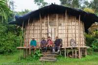 Kavorabip men & house, Genex, Star Mountains, Papua New Guinea.