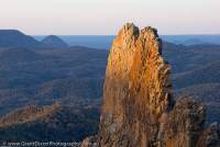 AUSTRALIA, NSW, Coonabarabran, Warrumbungle National Park. The Breadknife, a dyke, the solidified erosional remnants of the internal plumbing of an ancient volcano, sunset.